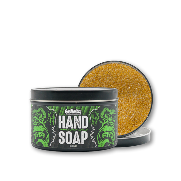 Front view of Gas Monkey Garage Hand Soap showcasing the gritty orange formula in an open tin on a white background