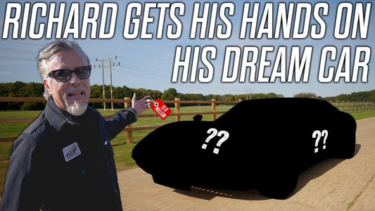 Richard Rawlings gestures toward a mystery car in a rural setting, promoting his dream car