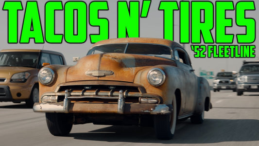 Tacos N’ Tires 1952 Fleetline driving on a road with other vehicles in the background