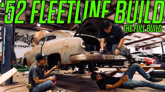 Mechanics work beneath and on a rusty 1952 Fleetline during the full build at Gas Monkey Garage
