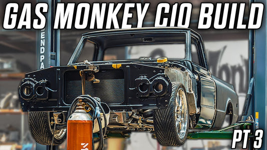 Rear view of a 1968 C10 truck under construction on a garage lift with Gas Monkey C10 Build and Part 3 text