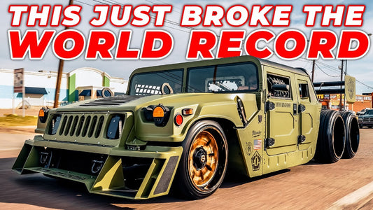 Front three-quarter view of a green 6x6 Humvee on a street; overlaid text reads This Just Broke the World Record