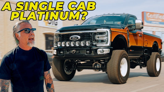Man standing beside a lifted orange-and-black Ford Super Duty truck with “A SINGLE CAB PLATINUM?” headline text