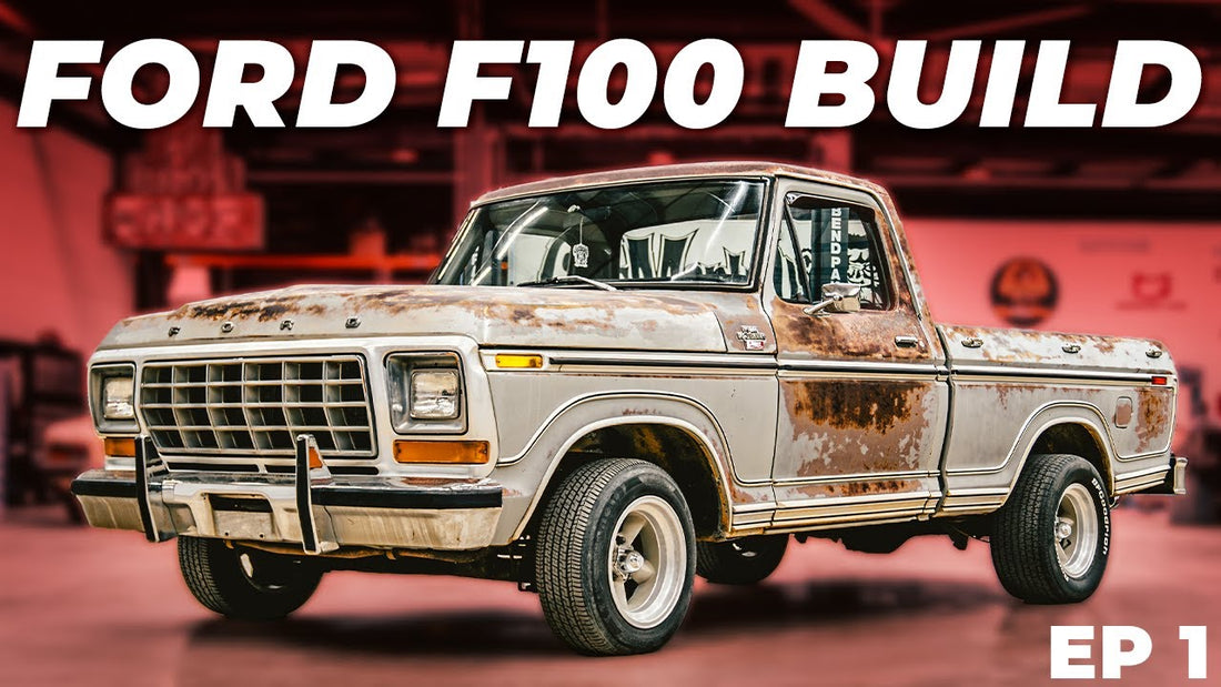 Front three-quarter view of a weathered 1978 Ford F100 pickup truck showcasing its vintage styling in a garage