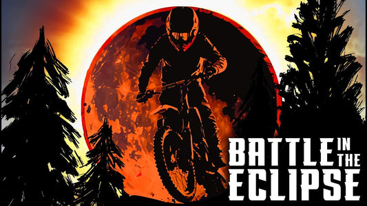 Motorcyclist rides toward a fiery eclipse between silhouetted trees