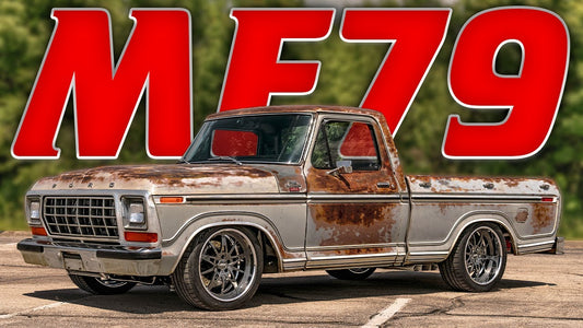 Front three-quarter view of a 1979 Ford F100 showcasing its patina finish and polished wheels with MF79 lettering behind it