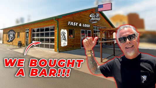 A man stands outside a Gas Monkey Bar and Grill building beside WE BOUGHT A BAR headline