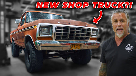 Orange vintage shop truck beside a man in a garage promoting the new shop truck rebuild