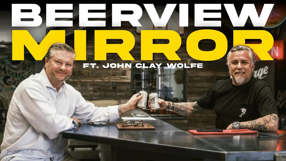 Two men toast at a bar beneath Beerview Mirror and Ft. John Clay Wolfe