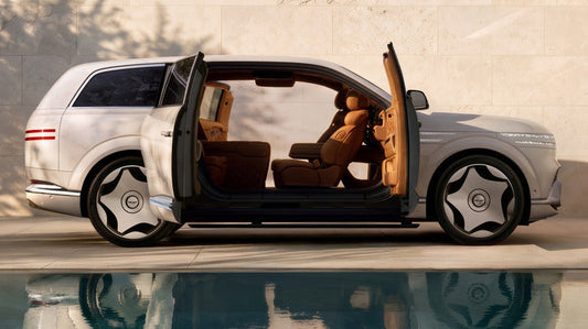 Side view of Genesis GV90 showcasing open doors and brown interior with a poolside background